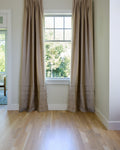 Coudre curtains hung on a window