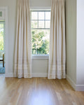 Coudre curtains hung on a window