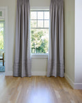 Coudre curtains hung on a window