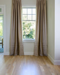 Coudre curtains hung on a window
