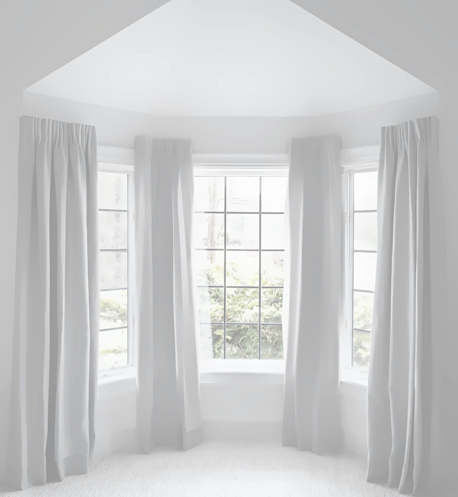 Coudre linen curtains in a bay window
